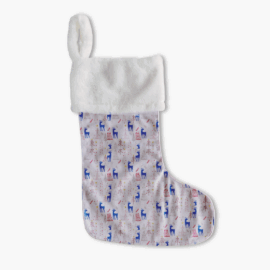 A Christmas stocking with a fluffy white cuff, decorated with blue reindeer, trees, and festive designs.